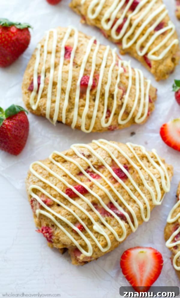 White Chocolate Strawberry Cream Scones 3 Close-up of a perfectly baked White Chocolate Strawberry Scone, showcasing its flaky texture and fresh strawberry pieces