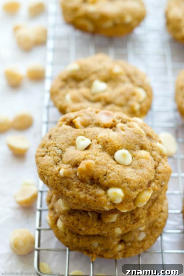 Freshly baked white chocolate macadamia nut cookies cooling on a wire rack