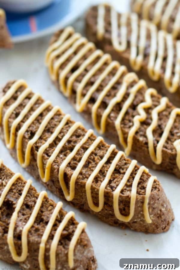 Indulgent chocolate biscotti drizzled generously with a creamy peanut butter glaze, ready to pair with your favorite coffee.