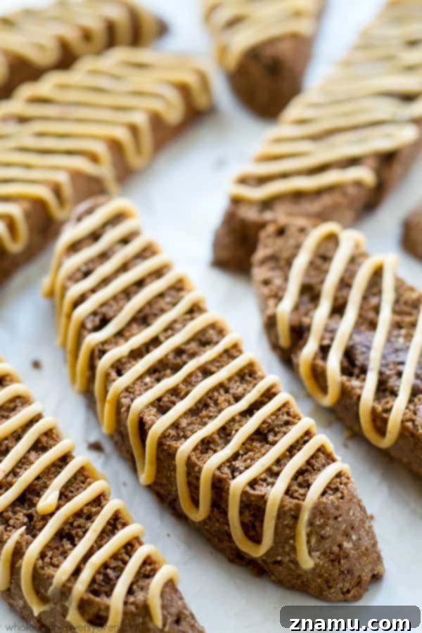 Freshly baked chocolate biscotti cooling on a rack, before being adorned with its signature peanut butter cream cheese glaze.