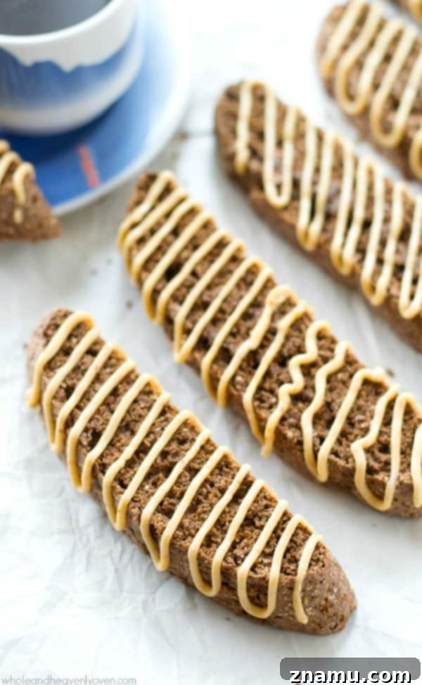 A delightful pairing of chocolate peanut butter biscotti with a steaming cup of coffee, promising a perfect moment of indulgence.