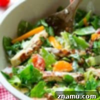 A vibrant chopped salad with grilled chicken and avocado ranch dressing.