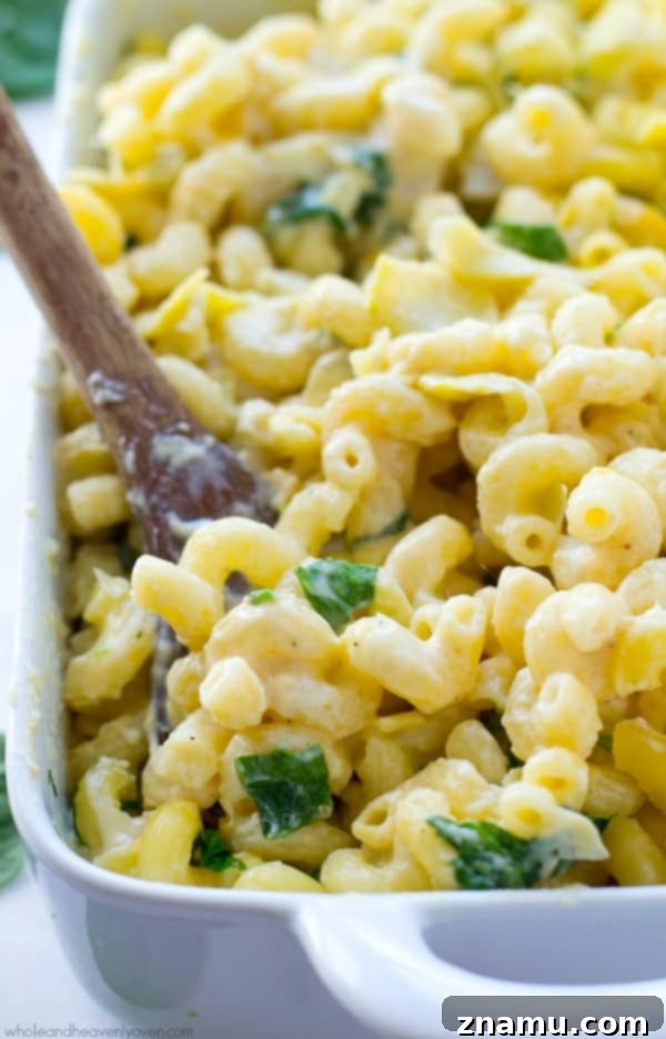 Creamy Spinach Artichoke Mac n Cheese 3 Close-up of macaroni and cheese with visible spinach and artichoke pieces