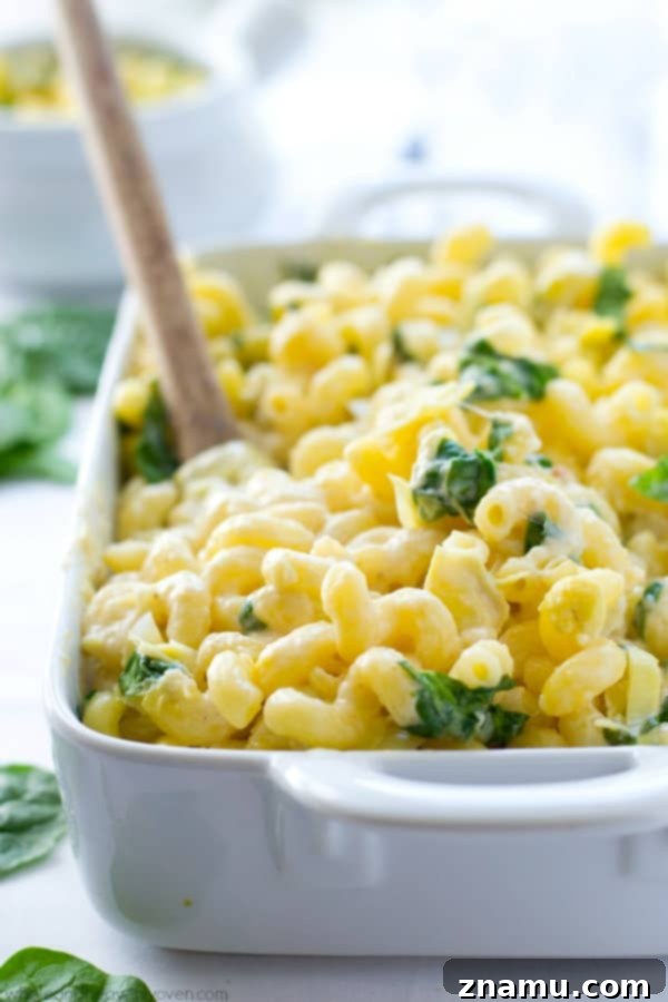 Creamy Spinach Artichoke Mac n Cheese 4 Irresistibly gooey cheese pull from freshly baked Spinach Artichoke Mac and Cheese