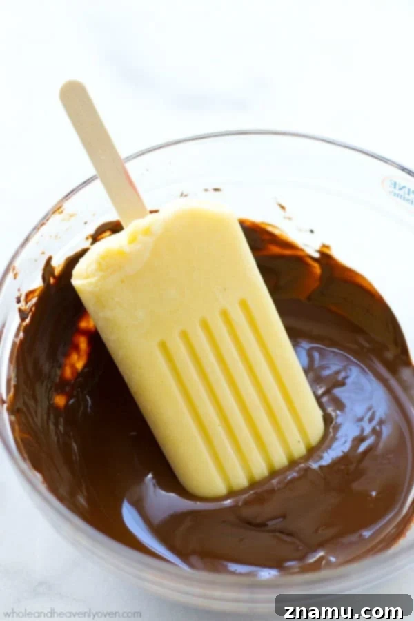 Mastering the Art of Chocolate Melting 7 A close-up of chocolate-dipped vanilla pudding popsicles, showcasing perfectly melted chocolate.