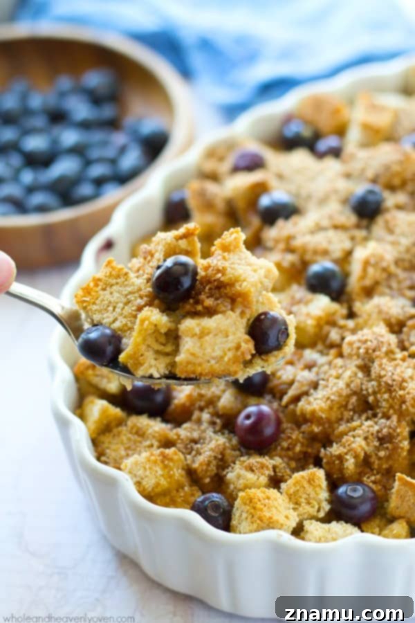Baked Blueberry Streusel French Toast Bliss 4 Overhead view of an overnight blueberry french toast casserole, fresh from the oven, with a rich golden streusel and vibrant blueberries.