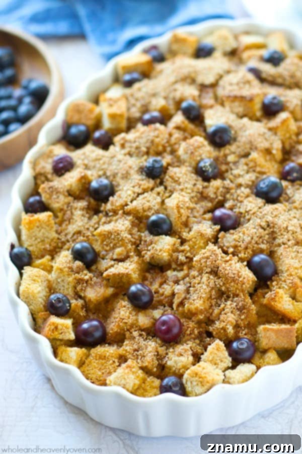 Baked Blueberry Streusel French Toast Bliss 5 A serving of moist blueberry french toast bake on a plate, showcasing the streusel and soft, custardy bread cubes.