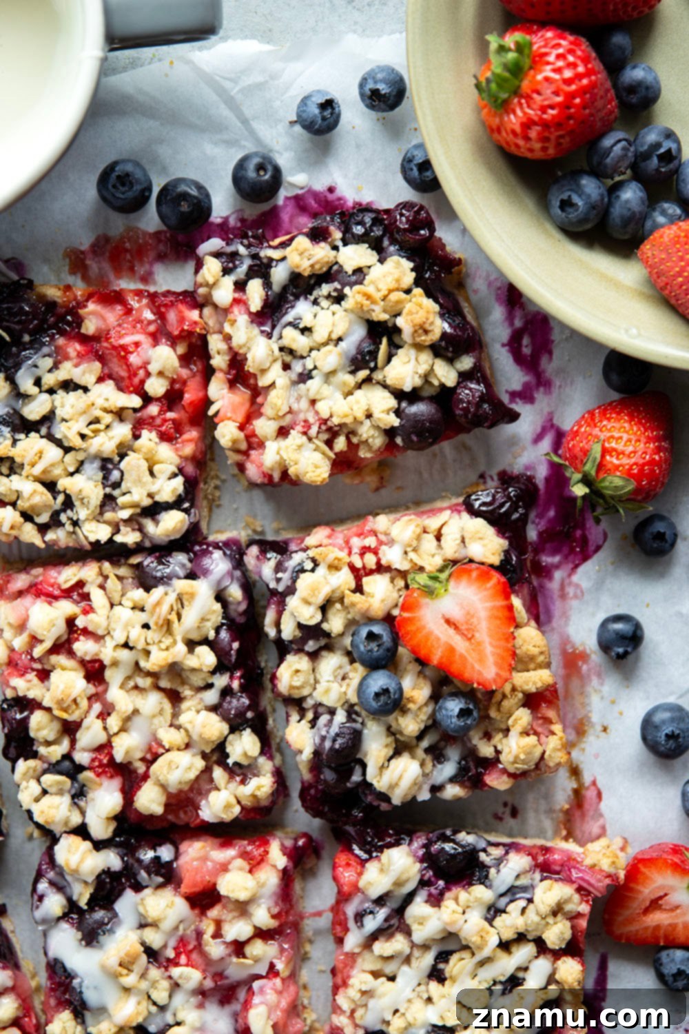 Liberty Layers 2 Loaded with a double whammy of berries, lots of streusel, and a creamy vanilla glaze, these red white and blue bars are an easy, festive treat for the 4th of July!