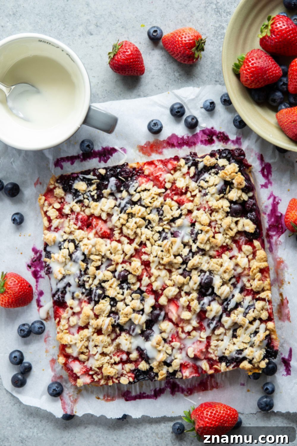 Liberty Layers 3 Loaded with a double whammy of berries, lots of streusel, and a creamy vanilla glaze, these red white and blue bars are an easy, festive treat for the 4th of July!