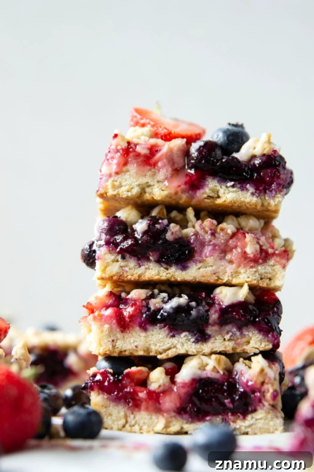 Liberty Layers 4 Loaded with a double whammy of berries, lots of streusel, and a creamy vanilla glaze, these red white and blue bars are an easy, festive treat for the 4th of July!