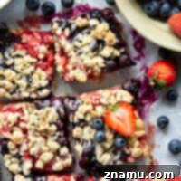 Loaded with a double whammy of berries, lots of streusel, and a creamy vanilla glaze, these red white and blue bars are an easy, festive treat for the 4th of July!