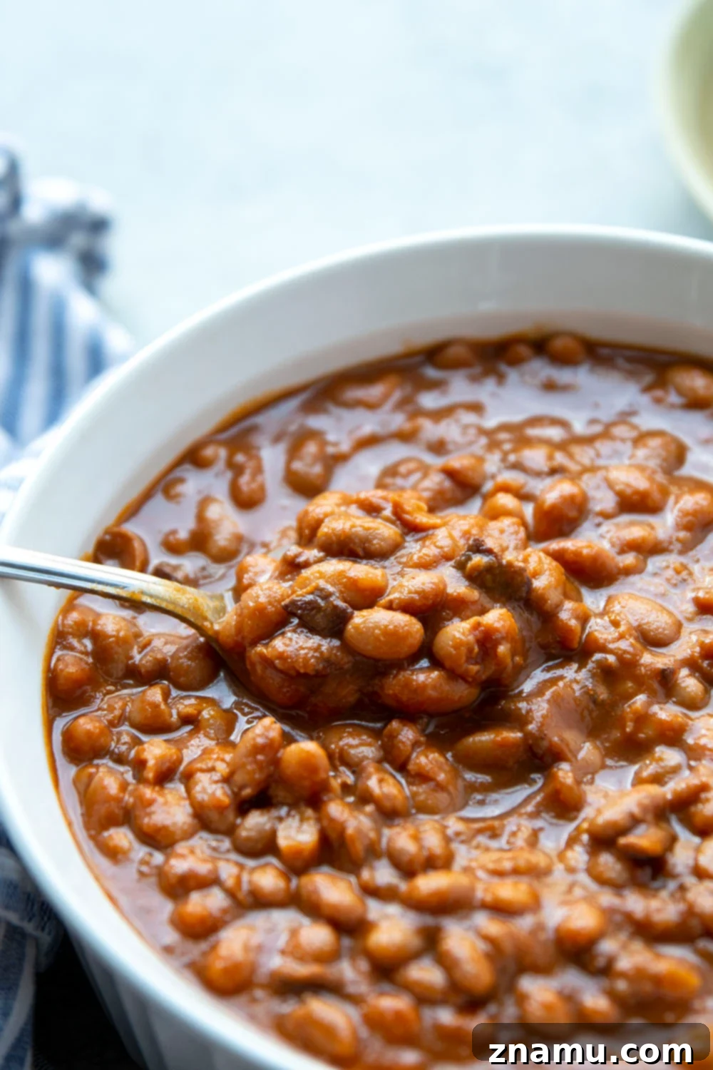 Flavorful slow cooker baked beans made from scratch, perfect for any cookout or barbecue as a hearty side dish.