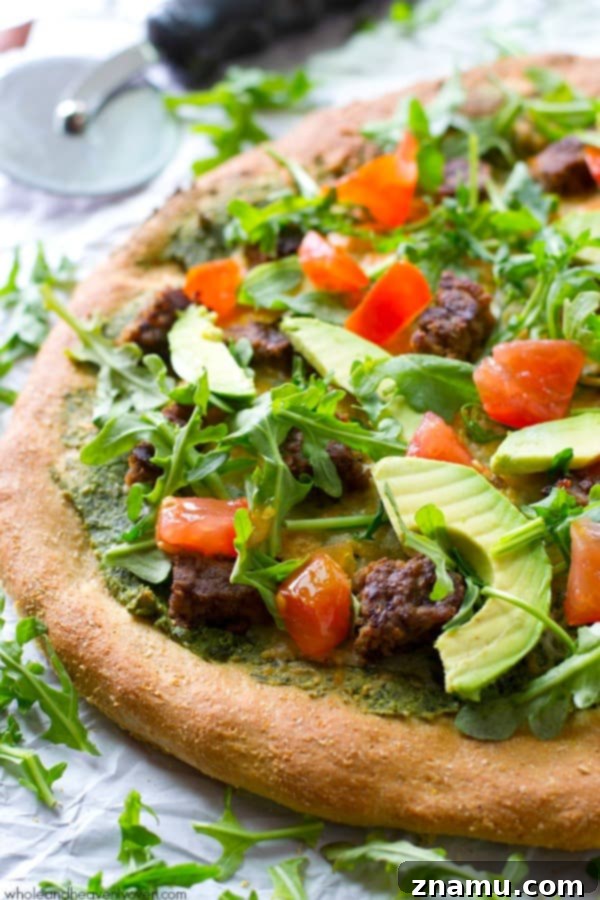 California Pesto Cheeseburger Pizza 2 Delicious California-style pesto pizza topped with veggie burgers, fresh tomatoes, arugula, and avocado, perfect for summer nights.