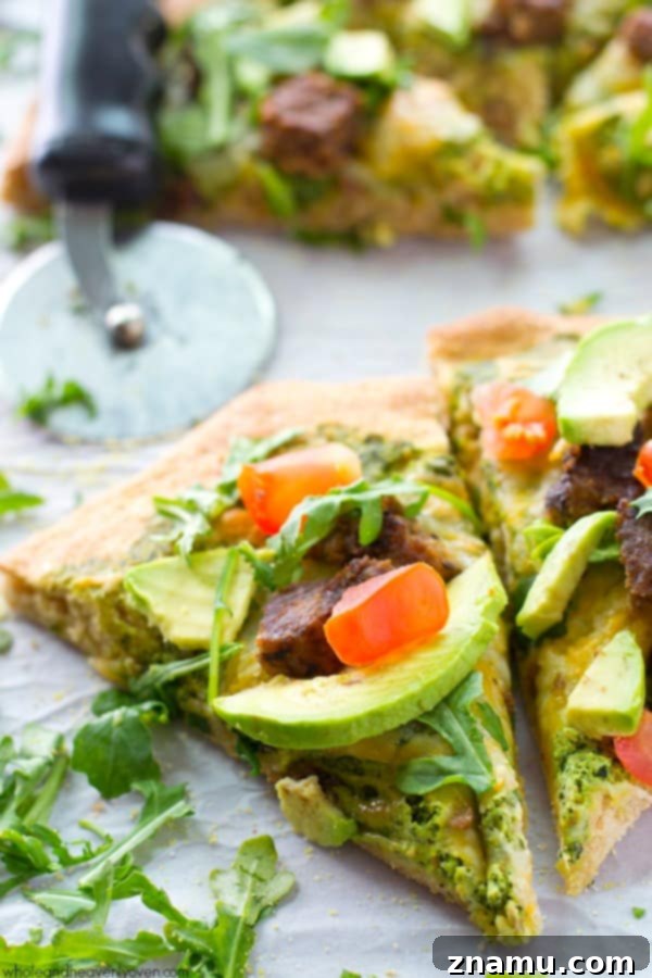 California Pesto Cheeseburger Pizza 4 A slice of California-style pizza showing the ricotta pesto base, cheese, and veggie burger pieces.