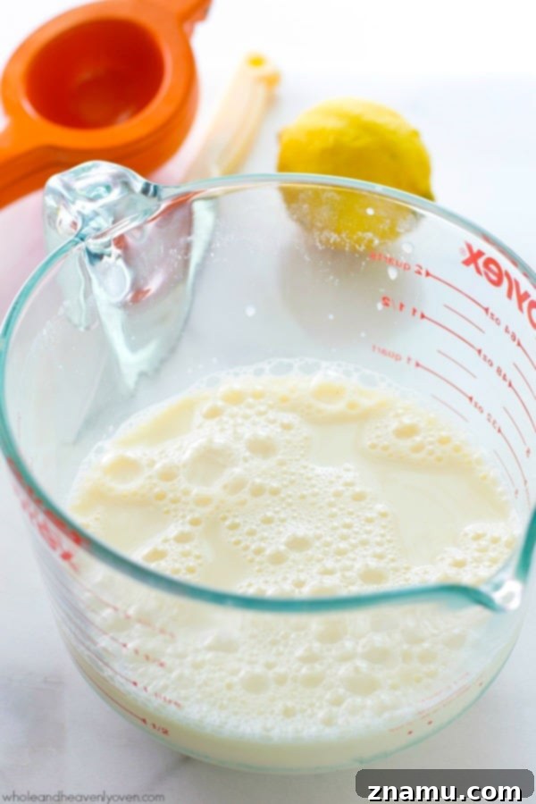 Buttermilk Magic: Just Two Ingredients 3 A close-up of a carton of milk and a fresh lemon on a kitchen counter, highlighting the simple ingredients for homemade buttermilk.