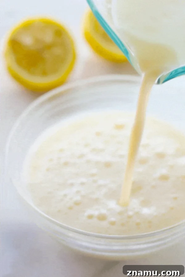 Buttermilk Magic: Just Two Ingredients 8 A close-up of a bowl of fluffy homemade buttermilk, showcasing its slightly thickened texture.