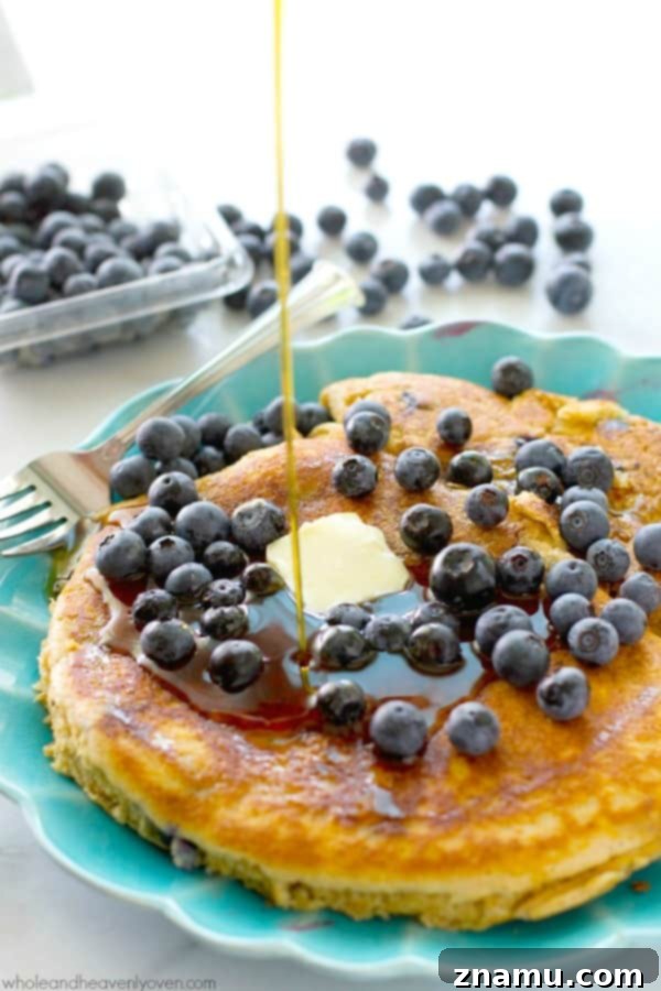 Colossal Buttermilk Blueberry Pancake 6 A freshly cooked XXL blueberry buttermilk pancake topped with a generous pat of butter and more fresh blueberries.
