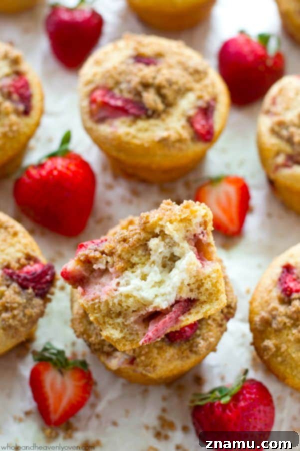 Decadent Strawberry Cheesecake Muffins 3 Close-up of fluffy Strawberry Cheesecake Muffins with crumb topping.