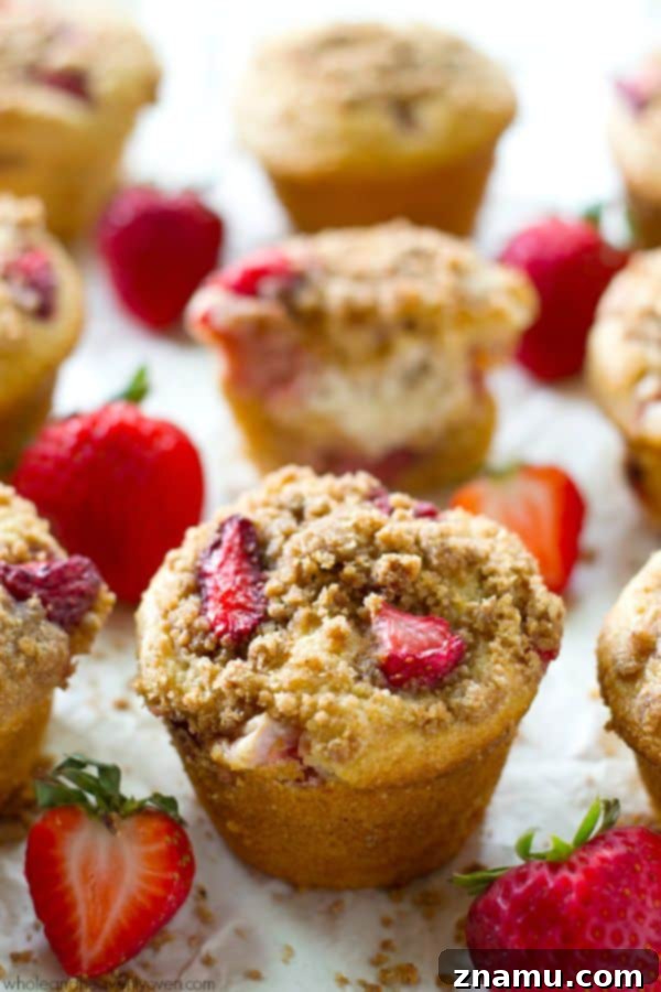 Decadent Strawberry Cheesecake Muffins 4 Freshly baked Strawberry Cheesecake Crumb Muffins cooling.