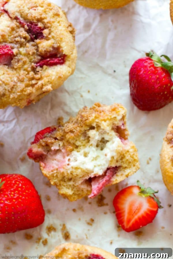 Decadent Strawberry Cheesecake Muffins 5 Cross-section of Strawberry Cheesecake Crumb Muffin showing filling.