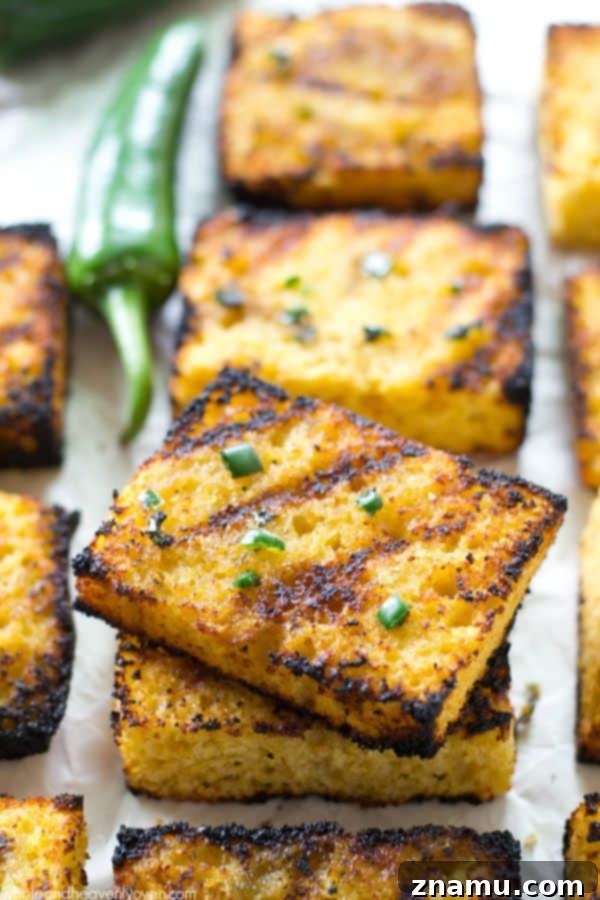 Honeyed Heat Griddle Cornbread 2 Grilled Cornbread with Jalapeno Honey Butter: Golden squares with char marks, glistening with melted butter.