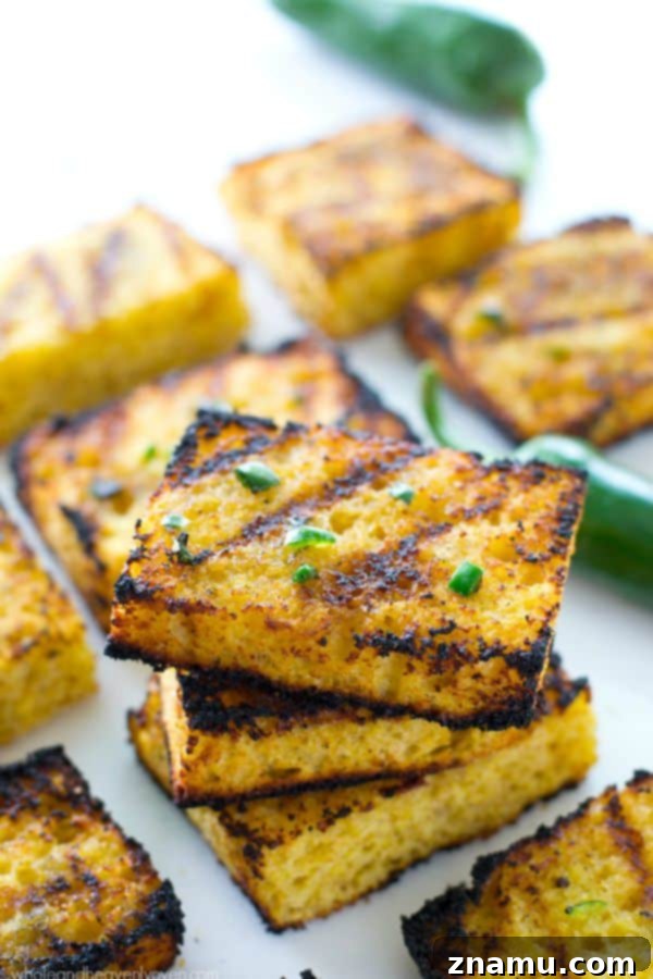 Honeyed Heat Griddle Cornbread 4 Perfectly grilled cornbread squares with distinct grill marks, ready to be served.