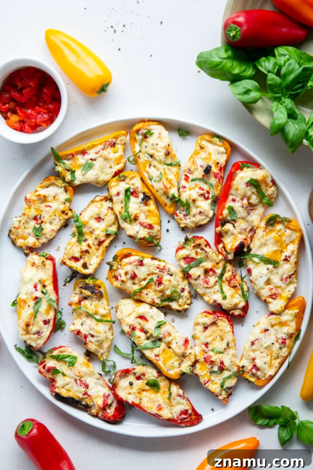 Fire-Kissed Sweet Pepper Bites 6 Grilled Sweet Pepper Poppers arranged on a serving plate with fresh basil.