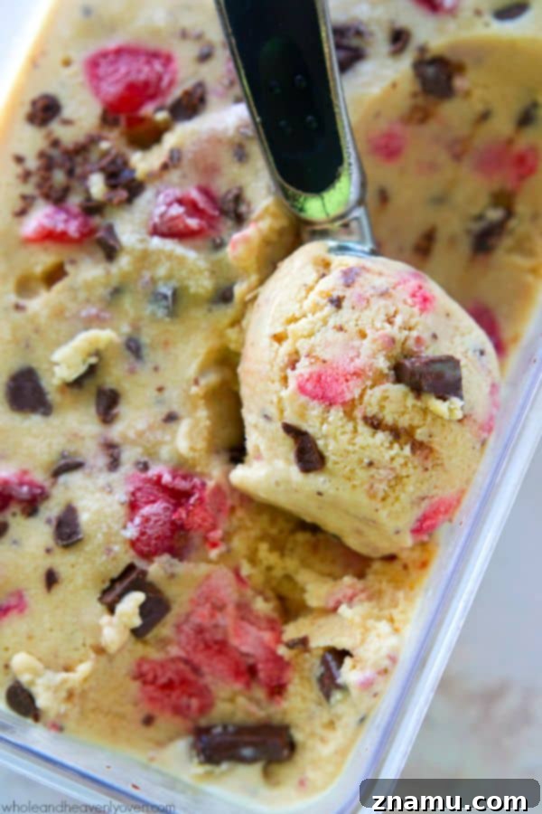 Crimson Chip Swirl Bliss 3 Close-up of Strawberry Swirl Chocolate Chip Ice Cream, showcasing creamy texture and chocolate chips.