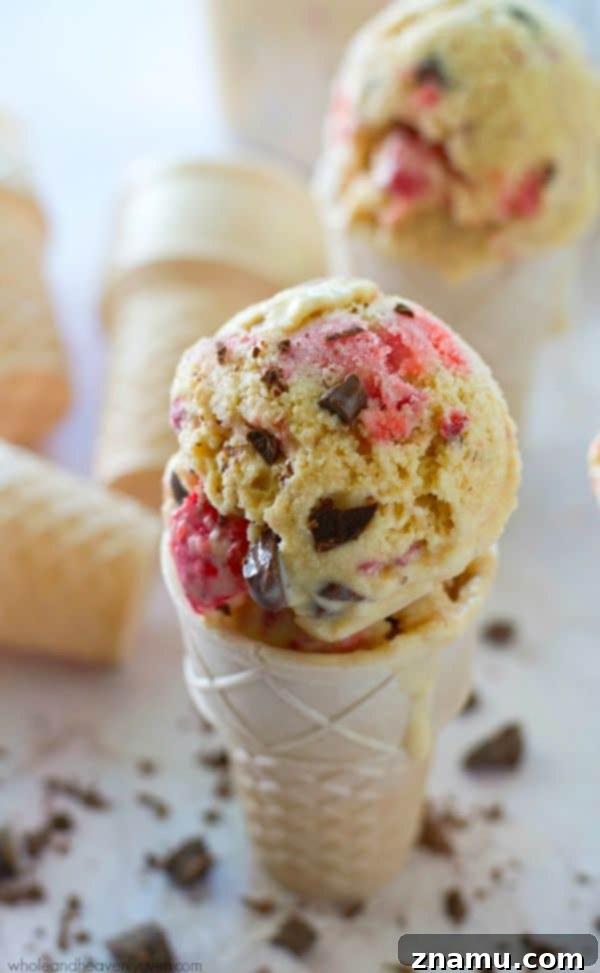 Crimson Chip Swirl Bliss 7 Strawberry Swirl Chocolate Chip Ice Cream in a clear glass bowl, showing the intricate swirls.