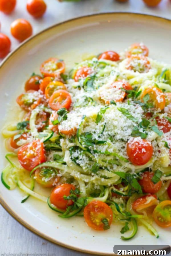 Light Parmesan Zoodles with Sweet Cherry Tomatoes 3 A close-up of fresh zucchini noodles before cooking, ready for a simple and healthy vegetarian meal.
