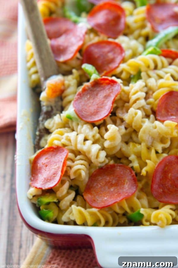 Ultimate Pepperoni Pizza Macaroni and Cheese 3 Close-up shot of bubbling pepperoni pizza mac and cheese, showcasing the vibrant colors of sauce and pepperoni.