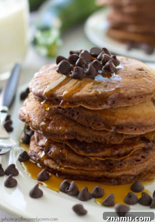 Decadent Double Chocolate Zucchini Pancakes 6 A close-up shot emphasizing the rich, chocolatey interior and fluffy edges of the Double Chocolate Zucchini Pancakes. @WholeHeavenly