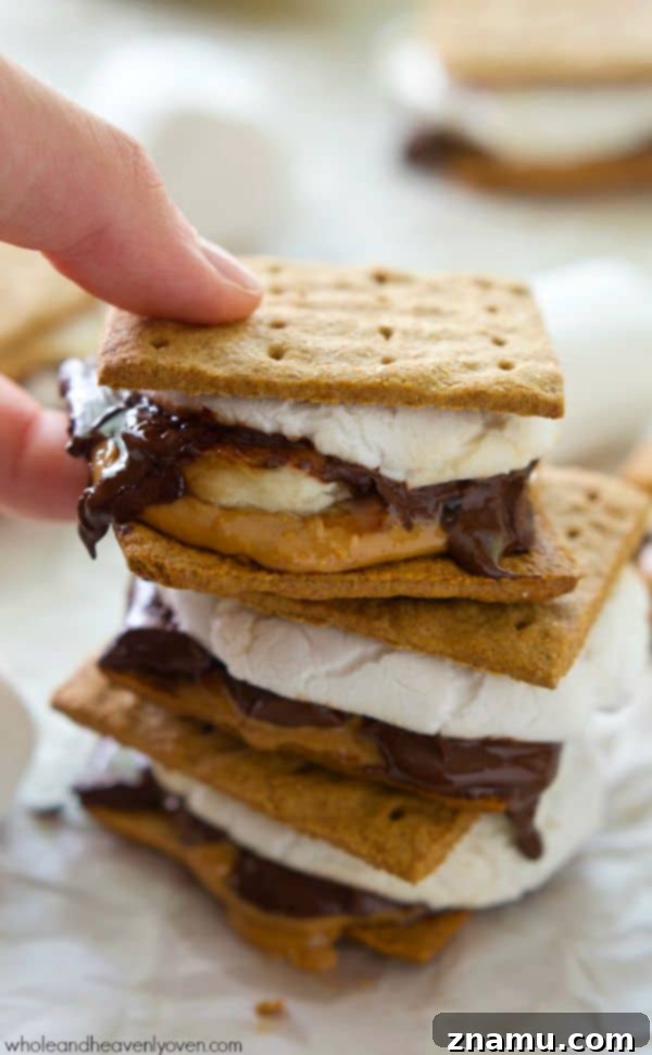 Detailed shot of a peanut butter banana s'more being pulled apart, revealing melted chocolate and marshmallow