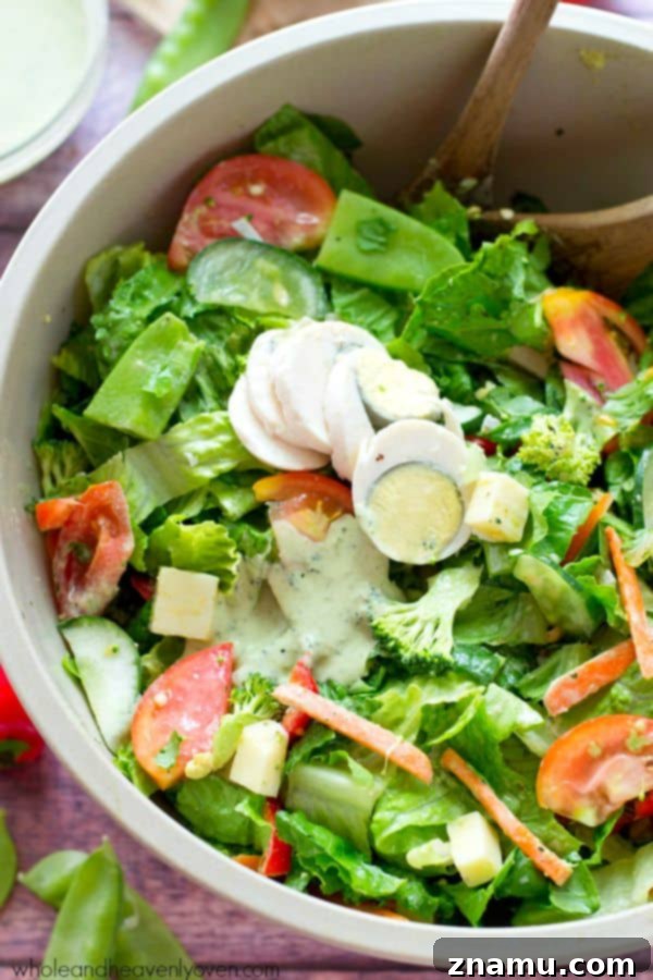 Vibrant Rainbow Veggie Chef's Salad with a creamy pesto ranch dressing in a large bowl, ready to be served.