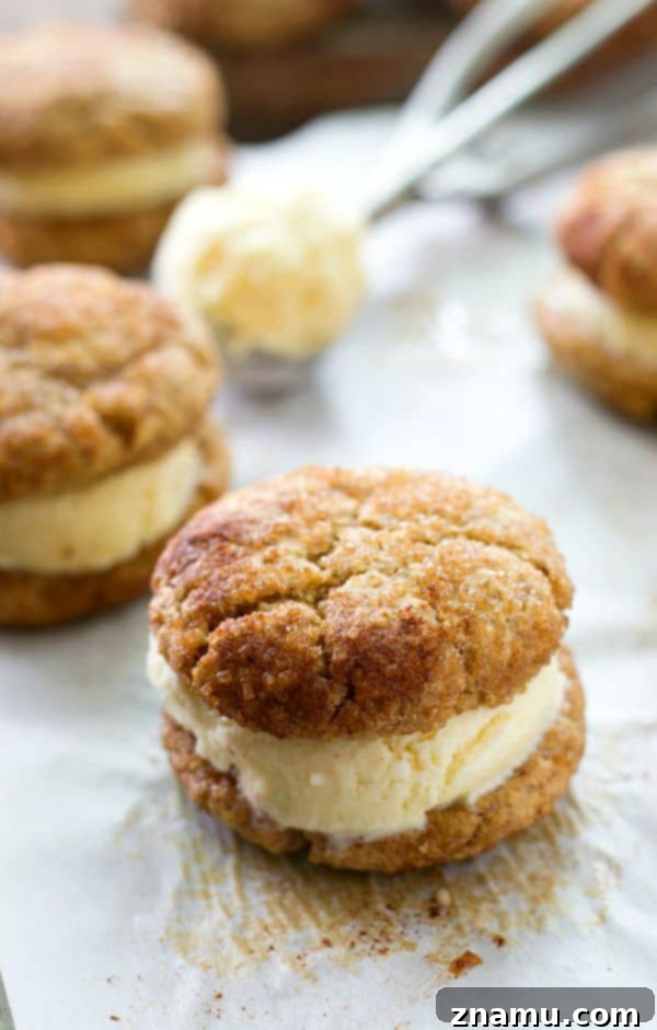 Cinnamon Sugar Cookie Cream Dreams 6 Several perfectly assembled snickerdoodle ice cream sandwiches stacked on a cooling rack.