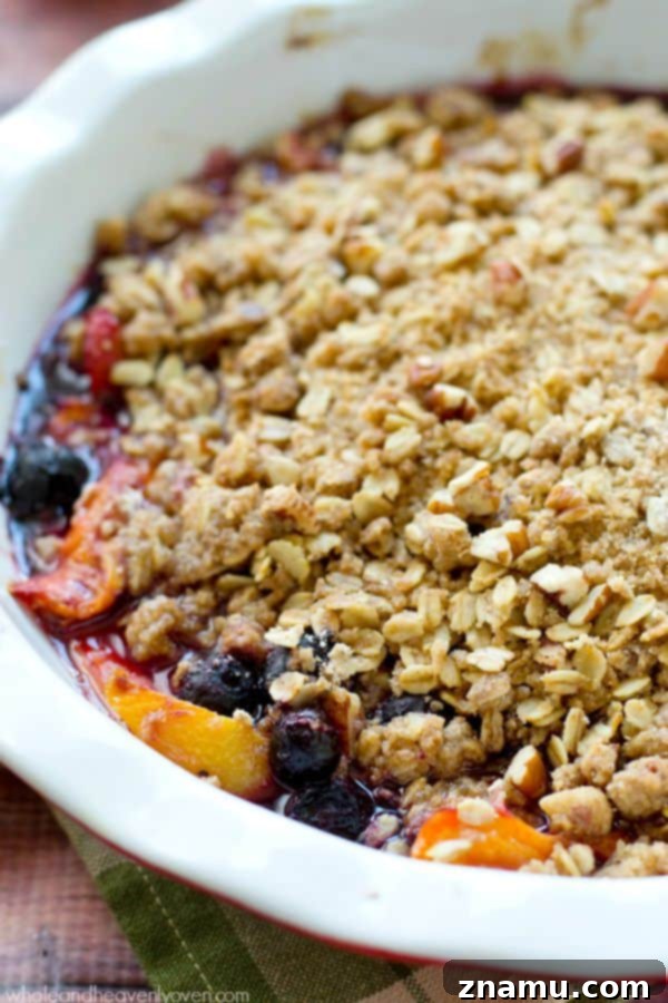 Sweet Peach Blueberry Oat Crumble 6 A dish of freshly baked peach and blueberry crumble, still warm and bubbly from the oven.