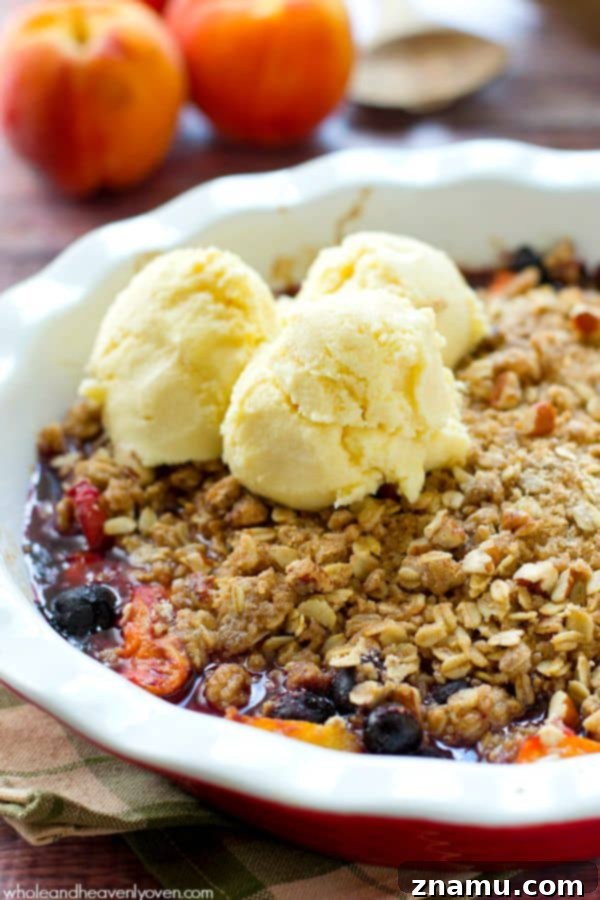 Sweet Peach Blueberry Oat Crumble 7 A large baking dish filled with a golden-brown peach and blueberry oatmeal crumble, fresh from the oven and ready to be served.