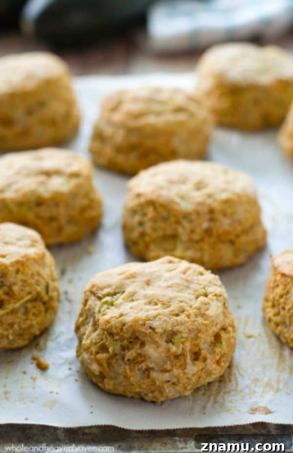 Savory Zucchini Parmesan Buttermilk Biscuits 2 Fluffy homemade zucchini parmesan buttermilk biscuits on a cooling rack.