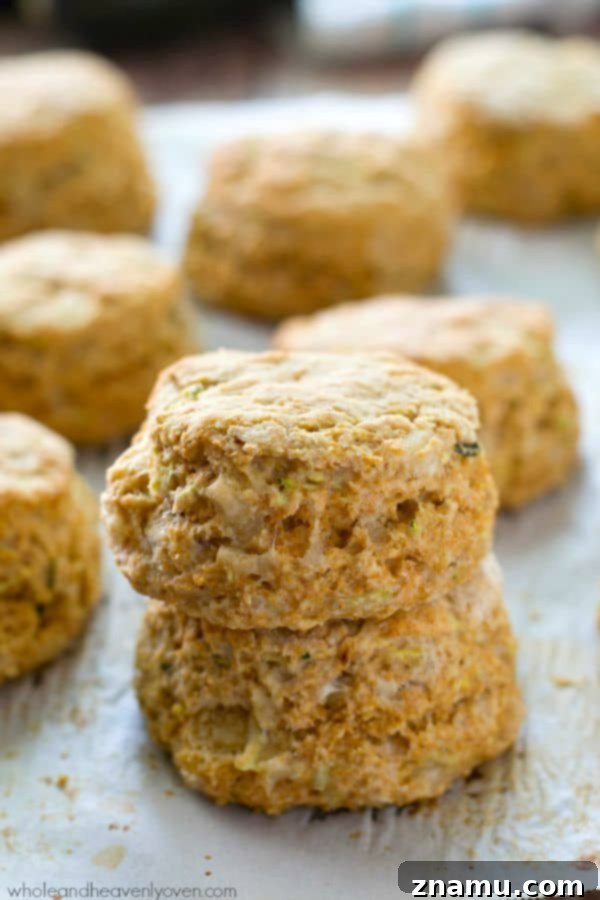 Savory Zucchini Parmesan Buttermilk Biscuits 3 Close-up of golden brown zucchini Parmesan biscuits showing their flaky layers.