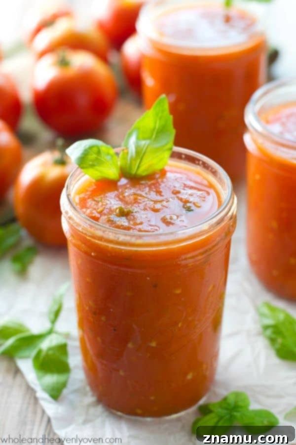 Slow-roasted for hours in plenty of herbs and garlic, this tomato sauce packs in the absolute BEST flavors of summer! --- It's awesome on top of pasta and freezes wonderfully. @WholeHeavenly