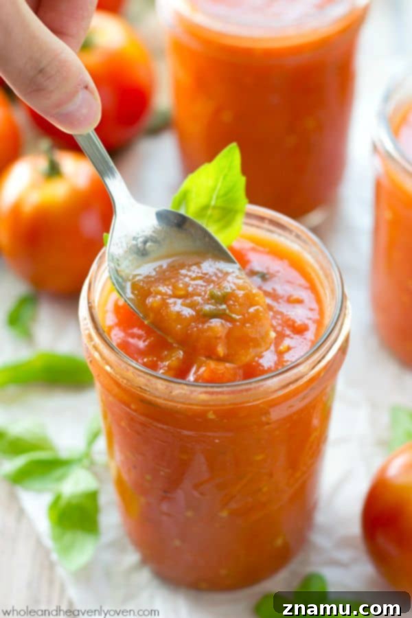 Slow-roasted for hours in plenty of herbs and garlic, this tomato sauce packs in the absolute BEST flavors of summer! --- It's awesome on top of pasta and freezes wonderfully. @WholeHeavenly