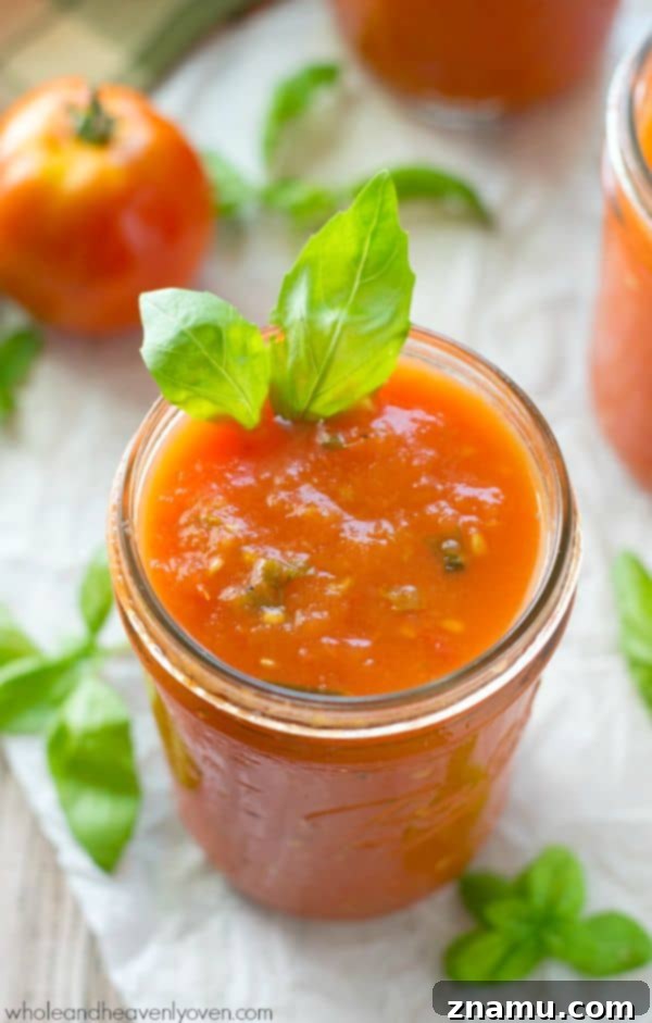 Slow-roasted for hours in plenty of herbs and garlic, this tomato sauce packs in the absolute BEST flavors of summer! --- It's awesome on top of pasta and freezes wonderfully. @WholeHeavenly
