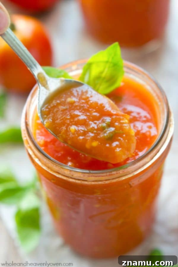 Slow-roasted for hours in plenty of herbs and garlic, this tomato sauce packs in the absolute BEST flavors of summer! --- It's awesome on top of pasta and freezes wonderfully. @WholeHeavenly