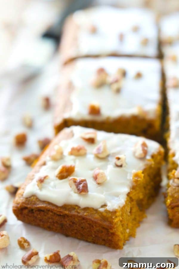 Velvet Pumpkin Spice Glaze Bars 5 A close-up of a single glazed pumpkin spice cake bar, showing its moist interior and perfect glaze.