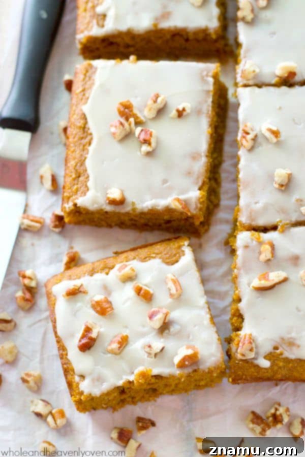 Packed with pumpkin 'n' spices, unbelievably soft inside, and covered with a luscious glaze, these easy cake bars are the perfect way to welcome fall!