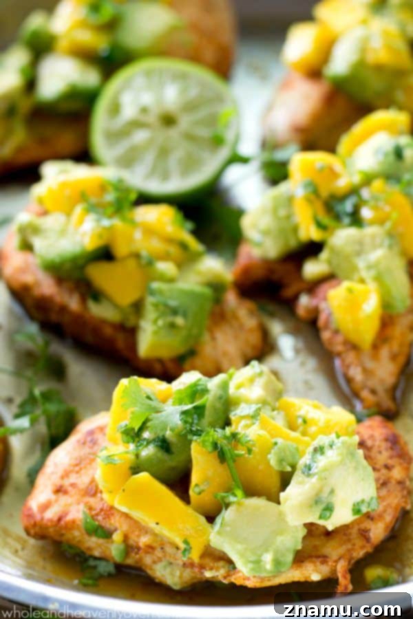 Bayou Blaze Chicken with Tropic Fruit Salsa 4 Close-up of golden brown cajun chicken tenders with fresh mango avocado salsa on top