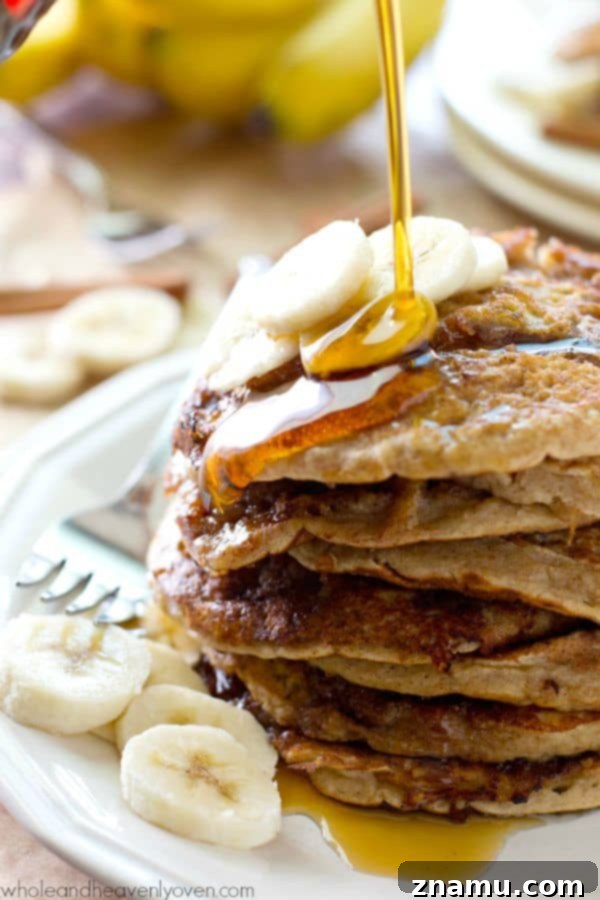 Bakery Banana Swirl Pancakes 3 Close-up shot of fluffy banana bread cinnamon roll pancakes, highlighting the gooey cinnamon swirl within each pancake, ready for a delicious bite.