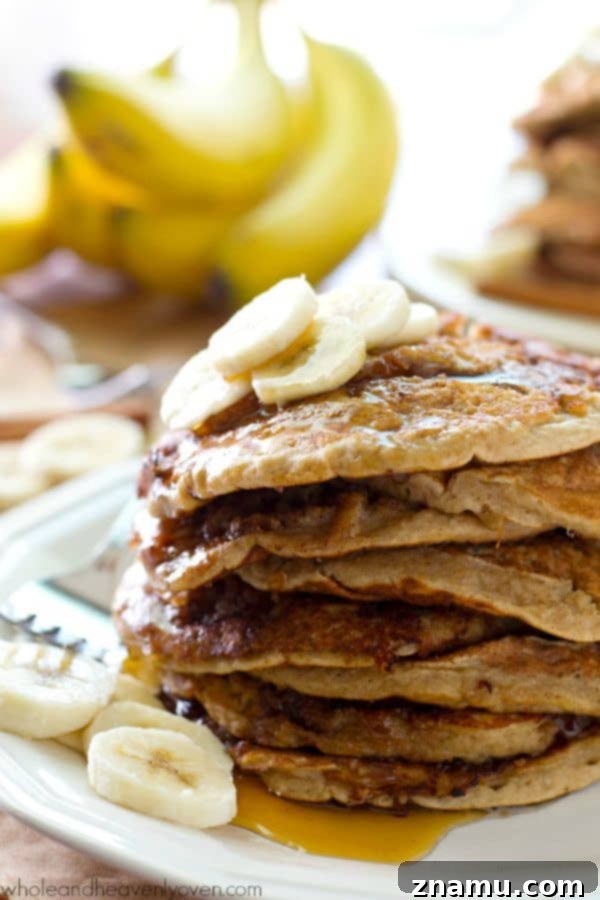 Bakery Banana Swirl Pancakes 4 A top-down view of a stack of golden brown pancakes, revealing the rich banana bread texture and vibrant cinnamon swirls, inviting a savory breakfast experience.