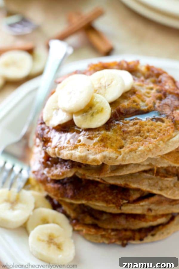 Bakery Banana Swirl Pancakes 5 Another enticing close-up of a stacked pancake, showcasing the moist interior and the prominent, sugary cinnamon roll swirl, promising a delightful treat.