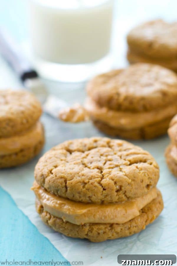 Homemade peanut butter sandwich cookies stacked with creamy peanut butter frosting in between. A nostalgic and classic dessert.